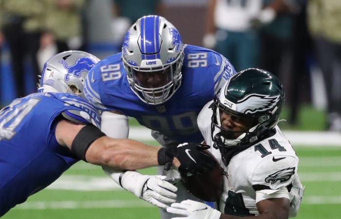 Detroit Lions inside linebackers Alex Anzalone (34) and Julian Okwara (99) tackle Philadelphia Eagles running back Kenneth Gainwell (14) during second half action at Ford Field Sunday, Oct. 31, 2021